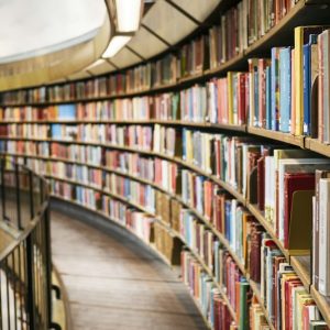 Curved library shelves filled with books and journals